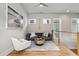 Comfortable upstairs sitting area with a modern couch, chair, and stylish accents creating a relaxing space at 6815 Halcyon Way, Alpharetta, GA 30005