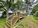 Charming cottage home with a wooden deck, stairs, and spacious yard, perfect for entertaining at 1238 Trenton St, Atlanta, GA 30316