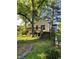 A wooden deck and stairs overlook the yard of this charming yellow cottage home at 1238 Trenton St, Atlanta, GA 30316