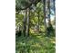 A view of the backyard of this charming cottage home shows lush greenery and lawn at 1238 Trenton St, Atlanta, GA 30316