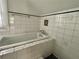 This tiled bathroom offers a soaking tub and plenty of space for luxurious bathing at 1238 Trenton St, Atlanta, GA 30316