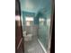 This bathroom features tiled walls, glass enclosed shower, and black and white tile floor at 1238 Trenton St, Atlanta, GA 30316