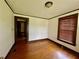 Bedroom featuring hardwood floors, a window, and an adjacent room at 1238 Trenton St, Atlanta, GA 30316