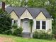 Charming yellow house with white trim, gabled roof, chimney, and welcoming front porch at 1238 Trenton St, Atlanta, GA 30316