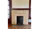 Close up on a brick fireplace with decorative elements, hardwood floor, and vintage charm at 1238 Trenton St, Atlanta, GA 30316