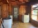 A cozy laundry room featuring wood-paneled walls, appliances, and a checkered ceiling at 1238 Trenton St, Atlanta, GA 30316