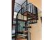 A spiral staircase with wooden treads and a black metal railing creates a focal point at 1238 Trenton St, Atlanta, GA 30316