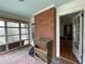 A sunroom that needs some updating has ample light from all the windows at 1238 Trenton St, Atlanta, GA 30316