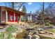 Charming backyard retreat featuring a rustic outbuilding, flowing creek, and manicured landscaping at 1352 Middlesex Ne Ave, Atlanta, GA 30306