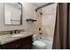 Well-appointed bathroom with granite countertop, dark wood vanity, and a shower with classic tile and dark fixtures at 1352 Middlesex Ne Ave, Atlanta, GA 30306