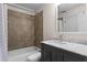 Bathroom with tub-shower combo, marble vanity, and neutral tile work at 1352 Middlesex Ne Ave, Atlanta, GA 30306