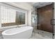 Bright bathroom with a large window, tub, and herringbone-patterned shower at 1352 Middlesex Ne Ave, Atlanta, GA 30306