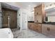 Modern bathroom featuring a walk-in shower, soaking tub, double vanity and marble floors at 1352 Middlesex Ne Ave, Atlanta, GA 30306