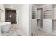 Bathroom leads to closet, featuring custom shelves and drawers with gold accents at 1352 Middlesex Ne Ave, Atlanta, GA 30306