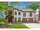 Charming two-story home with a stone accent wall, white stucco, and a well-manicured lawn at 1352 Middlesex Ne Ave, Atlanta, GA 30306