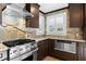 Modern kitchen boasts stainless steel appliances, marble countertops, and dark wood cabinets at 1352 Middlesex Ne Ave, Atlanta, GA 30306