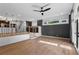 Open living room with dark walls, wood floors, and access to the kitchen, wet bar and back patio at 1352 Middlesex Ne Ave, Atlanta, GA 30306