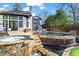 Stunning outdoor pool and spa with stone accents and a beautiful waterfall feature at 1352 Middlesex Ne Ave, Atlanta, GA 30306