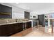 Contemporary wet bar area with marble countertop, wine fridge, dark wood cabinets, and grey accent wall at 1352 Middlesex Ne Ave, Atlanta, GA 30306
