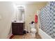 Bathroom featuring a shower-tub combo, a toilet, and a vanity with a sink and mirror at 1417 Sterlingbrooke Dr, Powder Springs, GA 30127
