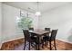 Cozy dining area with wood floors, a modern light fixture, and views of the backyard at 1417 Sterlingbrooke Dr, Powder Springs, GA 30127
