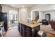 Spacious kitchen featuring an island, dark cabinetry, and views into adjacent rooms at 1417 Sterlingbrooke Dr, Powder Springs, GA 30127