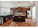 Well-equipped kitchen with dark wood cabinets, stainless steel appliances, and center island at 1417 Sterlingbrooke Dr, Powder Springs, GA 30127