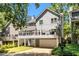 Rear exterior with a large deck, garage, and well-manicured yard at 2356 Defoors Ferry Nw Rd, Atlanta, GA 30318