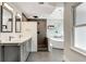 Modern bathroom featuring dual sinks, a soaking tub, and a walk-in shower with sleek tile work at 2356 Defoors Ferry Nw Rd, Atlanta, GA 30318