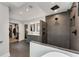 Elegant bathroom featuring a walk-in shower with dark tiling, dual sinks and a soaking tub at 2356 Defoors Ferry Nw Rd, Atlanta, GA 30318