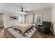 Bedroom with hardwood floors, a ceiling fan, windows, and a comfy gray armchair with a side table at 2356 Defoors Ferry Nw Rd, Atlanta, GA 30318