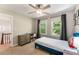 Comfortable bedroom filled with natural light from the bright windows and a ceiling fan at 2356 Defoors Ferry Nw Rd, Atlanta, GA 30318