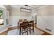 Cozy dining room with wainscoting, hardwood floors, and decorative lighting at 2356 Defoors Ferry Nw Rd, Atlanta, GA 30318