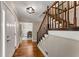 Welcoming foyer featuring hardwood floors, stairs to the upper level, and stylish lighting at 2356 Defoors Ferry Nw Rd, Atlanta, GA 30318