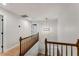 Upstairs hallway features a wooden railing and view to a stylish lighting fixture at 2356 Defoors Ferry Nw Rd, Atlanta, GA 30318