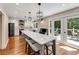 Spacious kitchen with a kitchen island, white cabinets, modern appliances, and access to the outdoor deck at 2356 Defoors Ferry Nw Rd, Atlanta, GA 30318