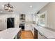 Modern kitchen featuring white cabinets, marble countertops, stainless steel appliances, and hardwood flooring at 2356 Defoors Ferry Nw Rd, Atlanta, GA 30318