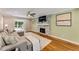 Bright living room featuring a fireplace, hardwood floors, and a comfortable sectional sofa at 2356 Defoors Ferry Nw Rd, Atlanta, GA 30318