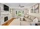Inviting living room featuring a stone fireplace, bay window, hardwood floors, and comfortable seating at 2356 Defoors Ferry Nw Rd, Atlanta, GA 30318