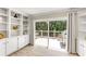 Bright living room with built-in shelving, wood floors, and sliding doors to outdoor deck at 2356 Defoors Ferry Nw Rd, Atlanta, GA 30318