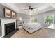Spacious main bedroom with a fireplace, neutral walls, a ceiling fan and bright windows at 2356 Defoors Ferry Nw Rd, Atlanta, GA 30318