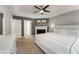 Spacious bedroom with a fireplace, tray ceiling, and a ceiling fan offering both comfort and elegance at 2356 Defoors Ferry Nw Rd, Atlanta, GA 30318