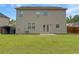 Back exterior of home with spacious backyard, storage shed, and solar panels at 3062 Hawthorn Farm Blvd, Loganville, GA 30052