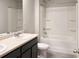 Clean bathroom features a double sink vanity and a shower-tub combo at 3062 Hawthorn Farm Blvd, Loganville, GA 30052