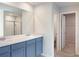 Updated bathroom vanity with dual sinks, large mirror, and entrance to walk-in closet at 3062 Hawthorn Farm Blvd, Loganville, GA 30052