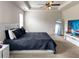 Bright bedroom with tray ceiling, carpet, large television and fashionable decor at 3062 Hawthorn Farm Blvd, Loganville, GA 30052