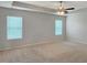 Spacious bedroom features soft carpet, bright natural light, and a ceiling fan at 3062 Hawthorn Farm Blvd, Loganville, GA 30052