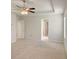 Bright bedroom with tray ceiling and fan fixture and multiple doorways at 3062 Hawthorn Farm Blvd, Loganville, GA 30052