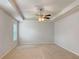 Large bedroom with plush carpet, bright natural light, and tray ceiling with ceiling fan at 3062 Hawthorn Farm Blvd, Loganville, GA 30052