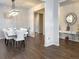 Bright dining room featuring modern lighting and dark hardwood floors at 3062 Hawthorn Farm Blvd, Loganville, GA 30052